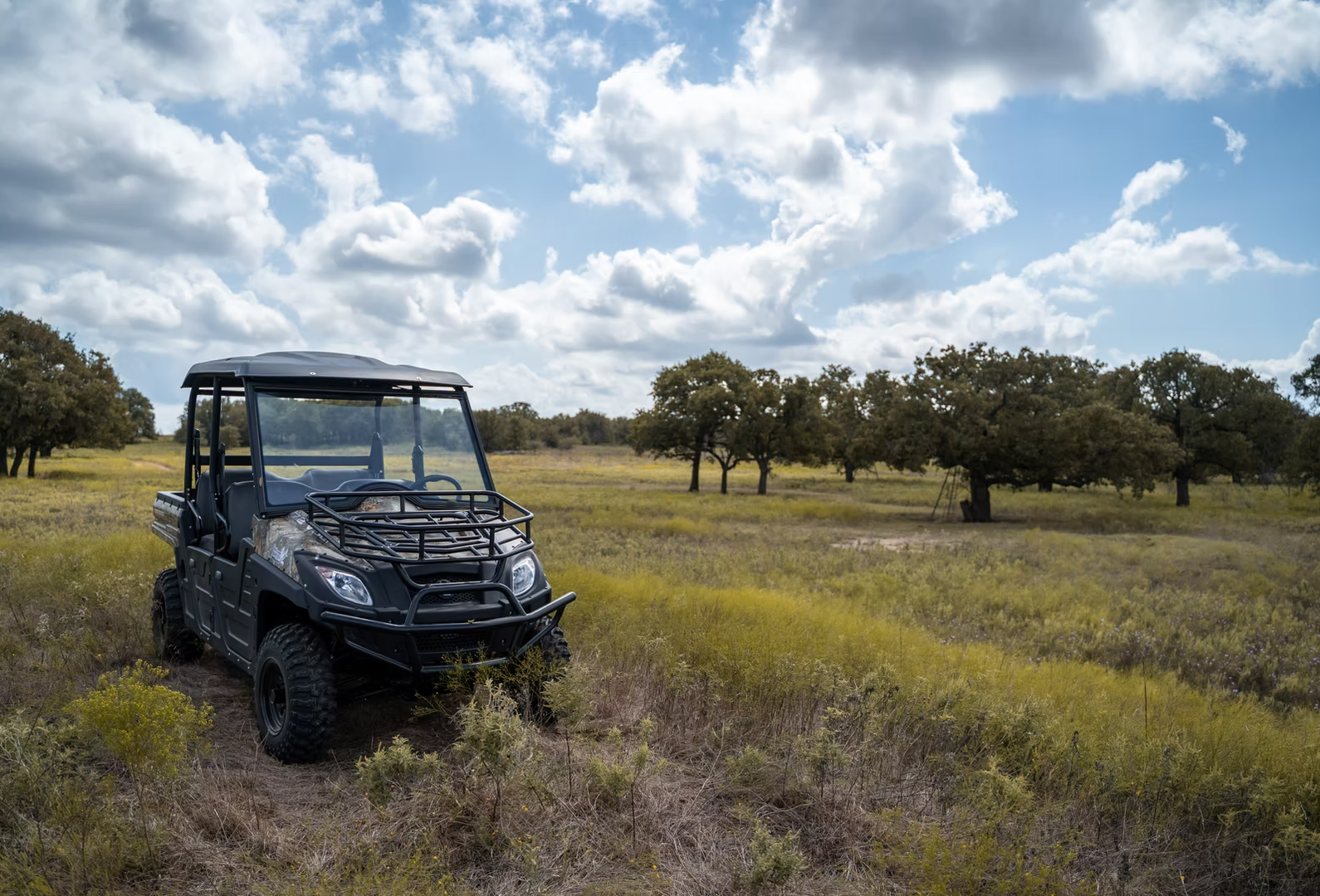 Heavy-duty off-road utility vehicle featuring Double A-arm independent suspension for side by side driving across open pastures.