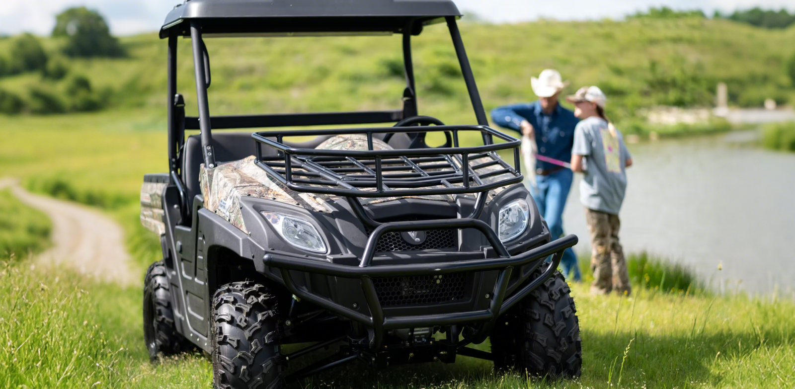 An off-road utility vehicle parked on a lakeside grassy terrain while people fish, highlighting a gas powered UTV capable of cross-country recreation.