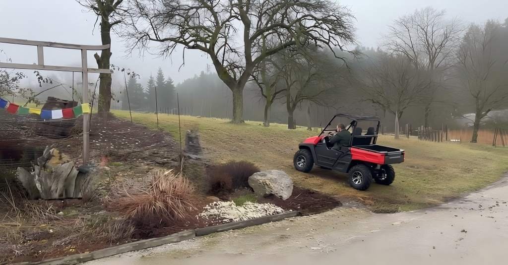 A heavy-duty electric UTV parked on a muddy farm road, demonstrating off-road traction and utility work capability