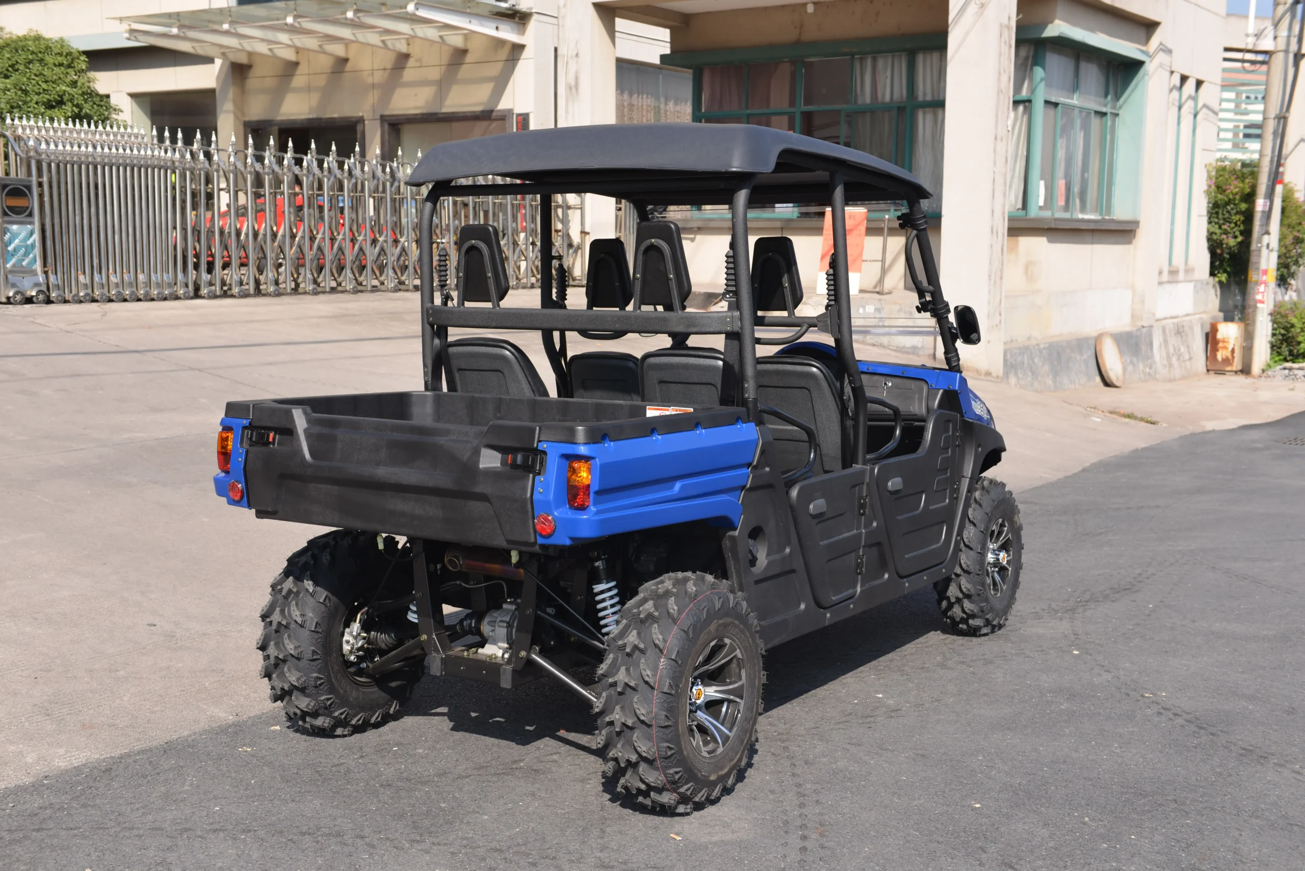 Rear view of a crossover UTV showing heavy-duty cargo bed and independent suspension setup