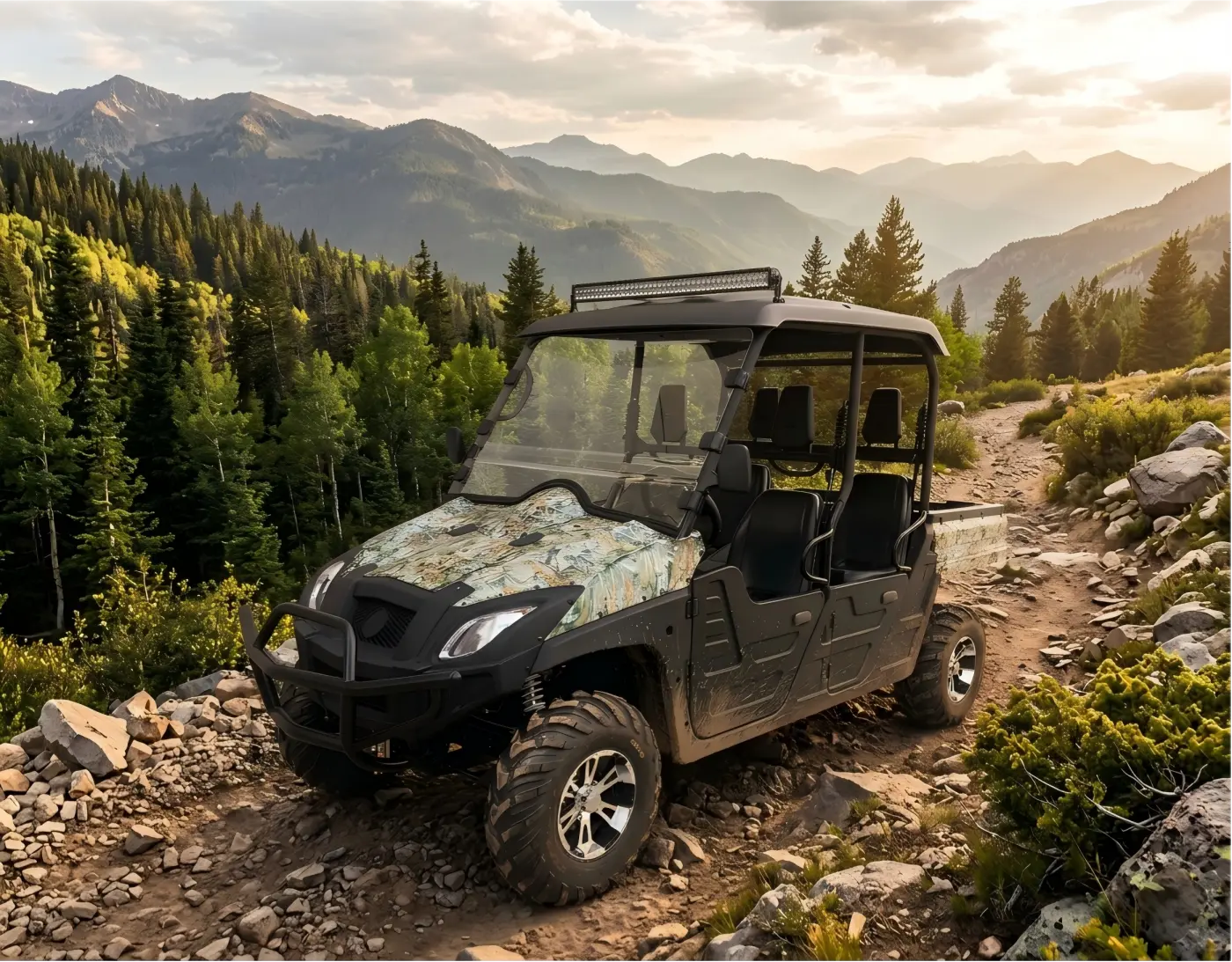 Electric UTV parked on a rugged mountain trail, highlighting durable tire tread and off-road chassis design.
