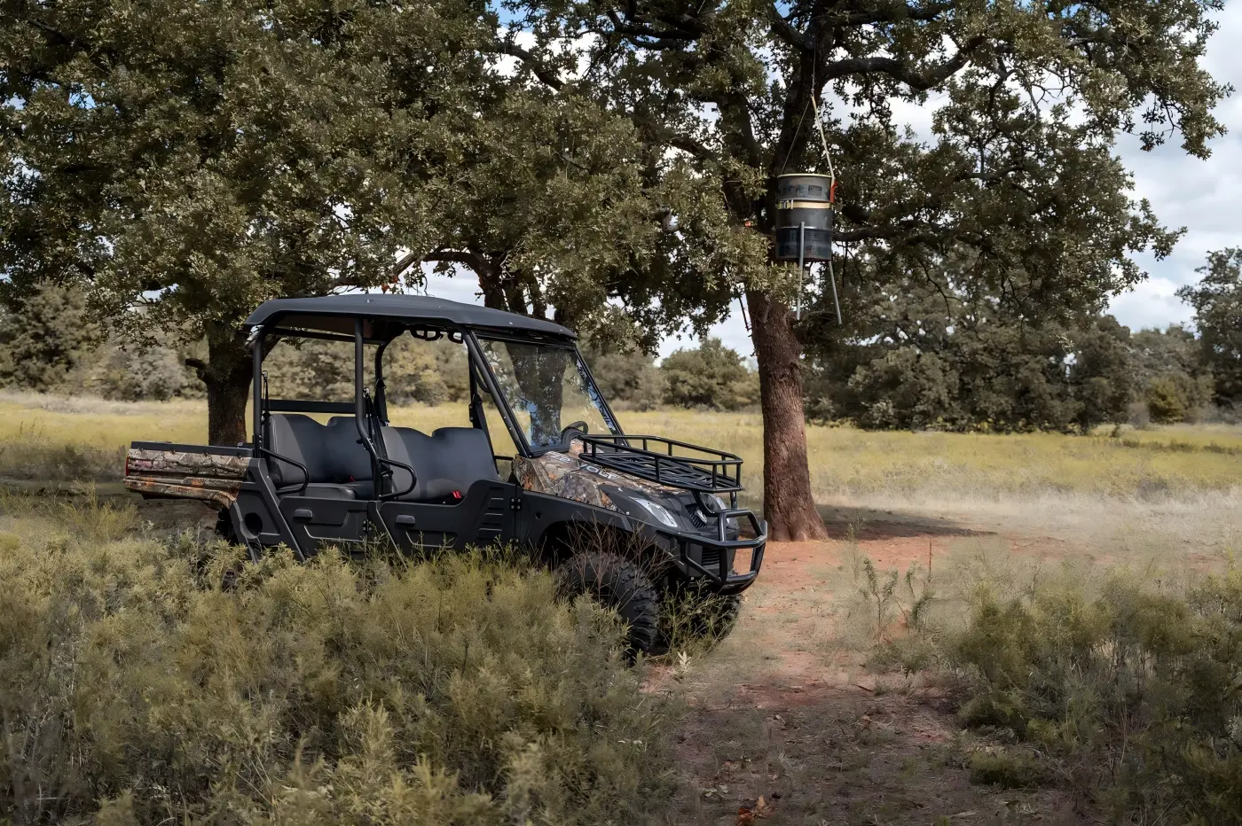 4-seat gasoline UTV exploring forest terrain during family outdoor trip