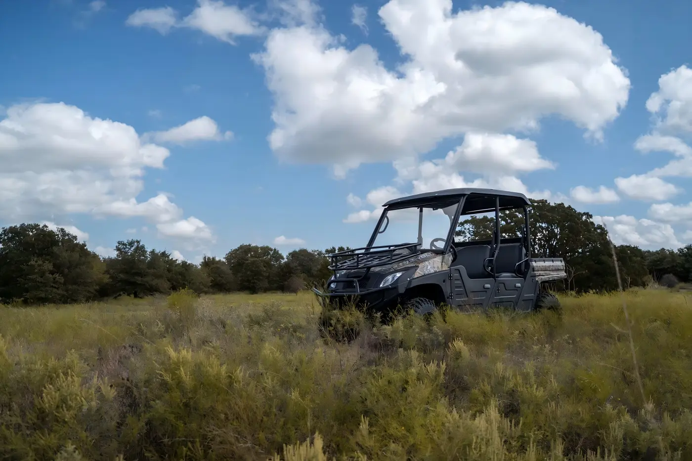 4-seat gasoline UTV exploring forest terrain during family outdoor trip