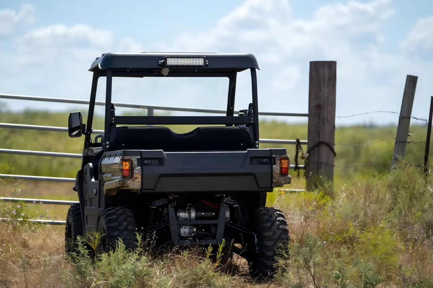 A fuel-powered UTV performing farm duties and off-road tasks in an outdoor field, demonstrating high load capacity and all-terrain versatility.