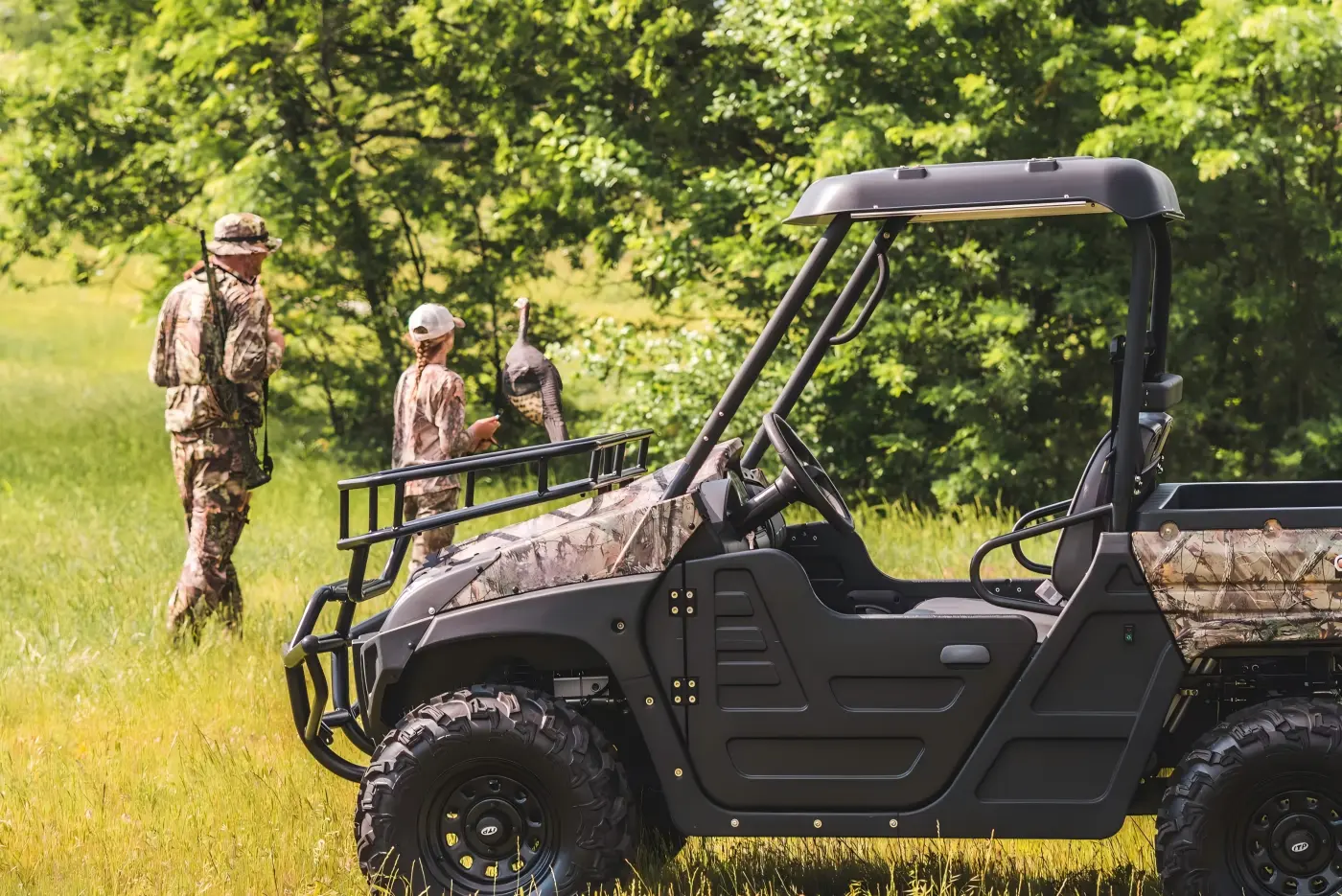 Field personnel with a commercial gasoline UTV during outdoor ranch and farm operations