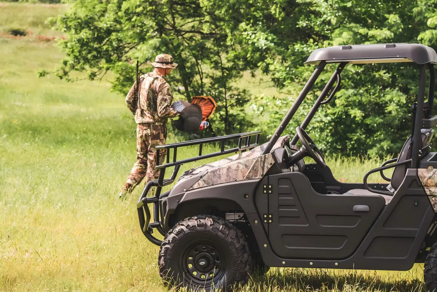 Operator loading equipment into a commercial gasoline UTV during farm and ranch operations