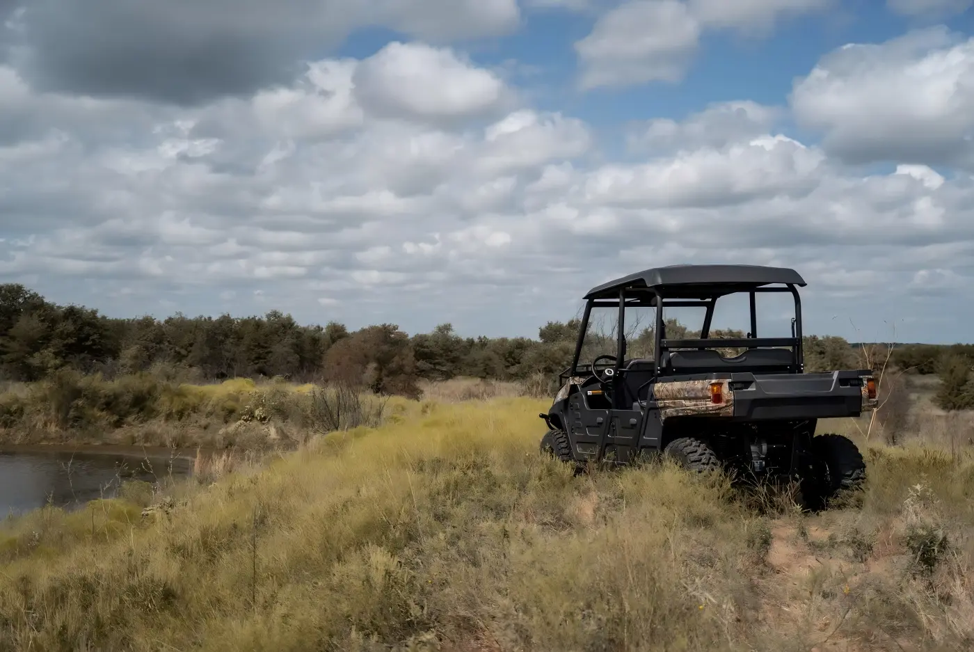 4-seat gasoline UTV exploring forest terrain during family outdoor trip