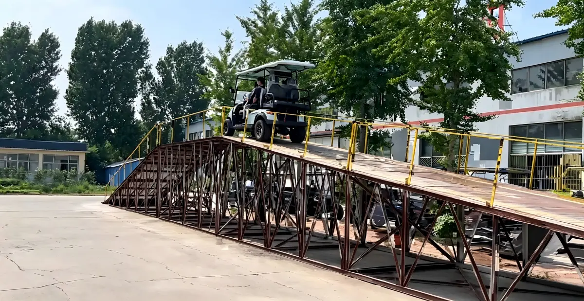 Electric golf cart tested for hill climbing performance and hill-hold control on a steep incline ramp under a full load.