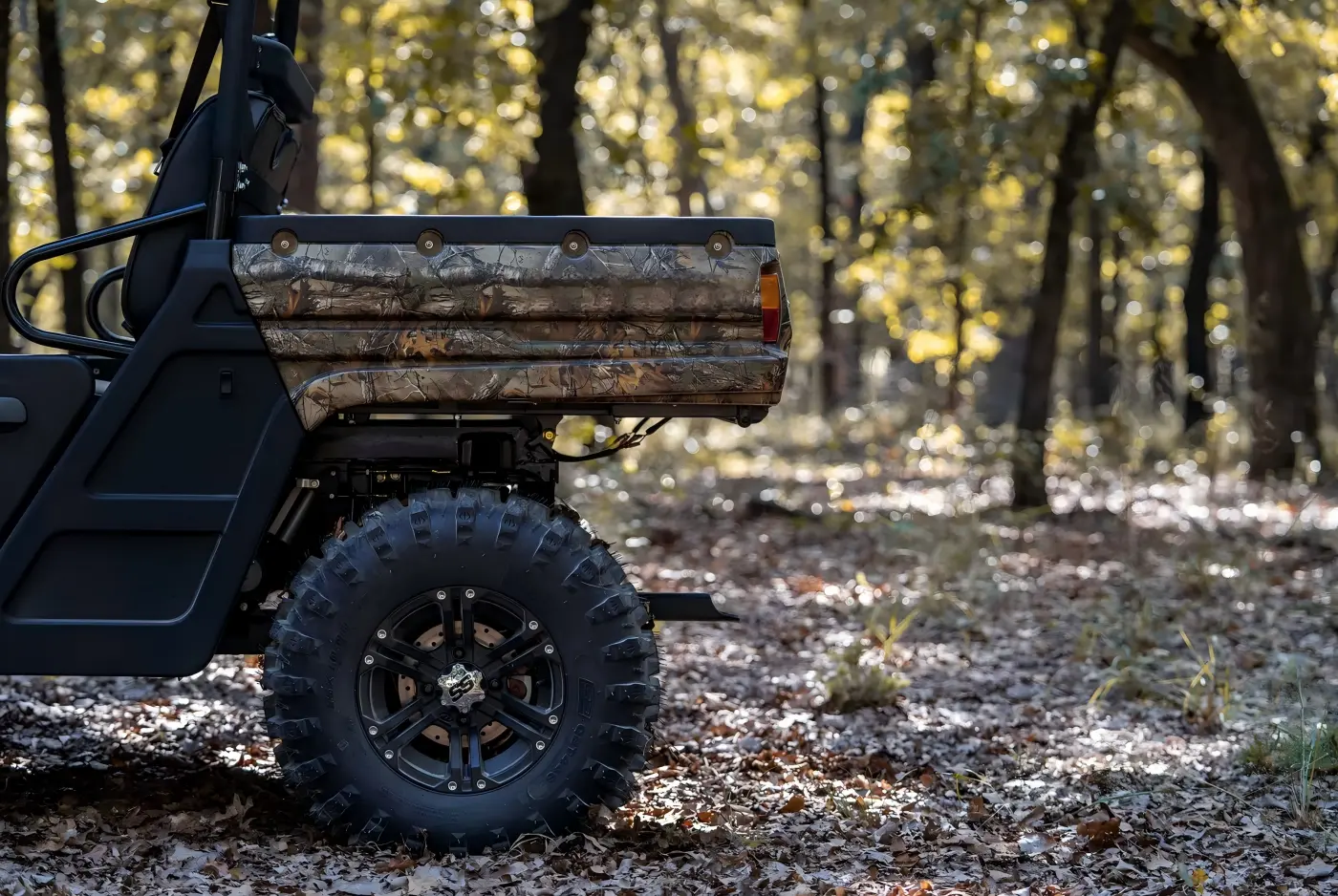 Rear cargo box and all-terrain tires of a gasoline UTV for farm transportation and trail riding