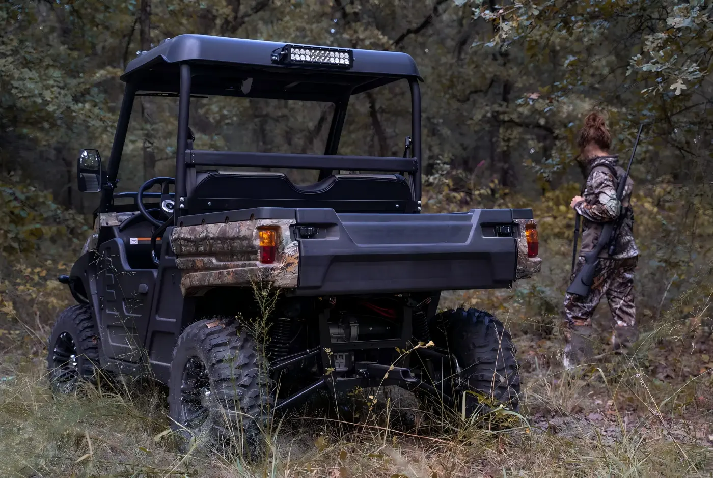 Custom fuel UTV designed for outdoor hunting and cross-country recreation in woodland