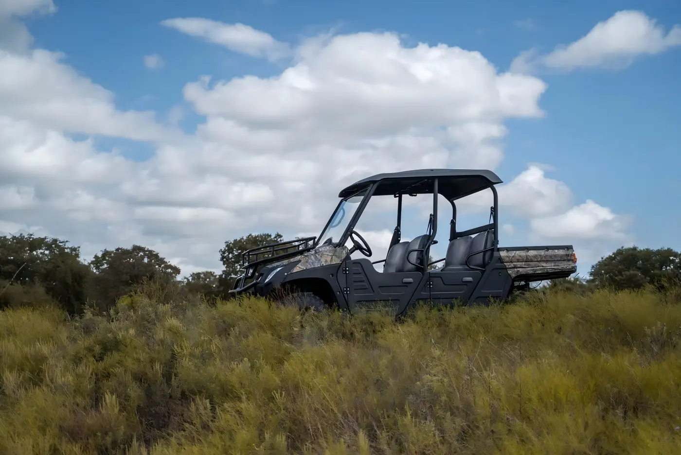 4-seat gasoline UTV exploring forest terrain during family outdoor trip