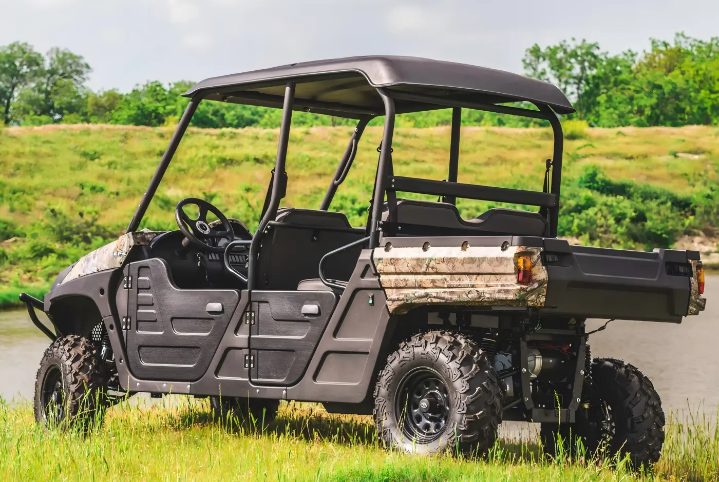 Side-rear view of a commercial 4-seat gasoline UTV parked outdoors for farm and utility operations