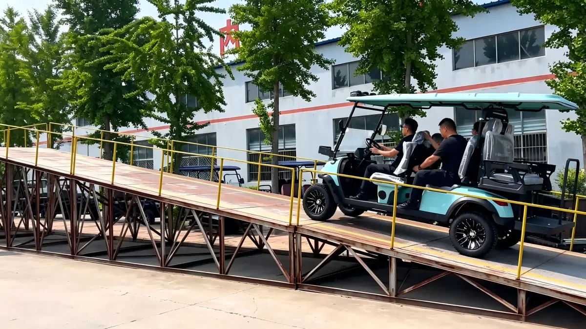 Electric golf cart starting a hill climbing test on a professional ramp, demonstrating chassis clearance and stability.