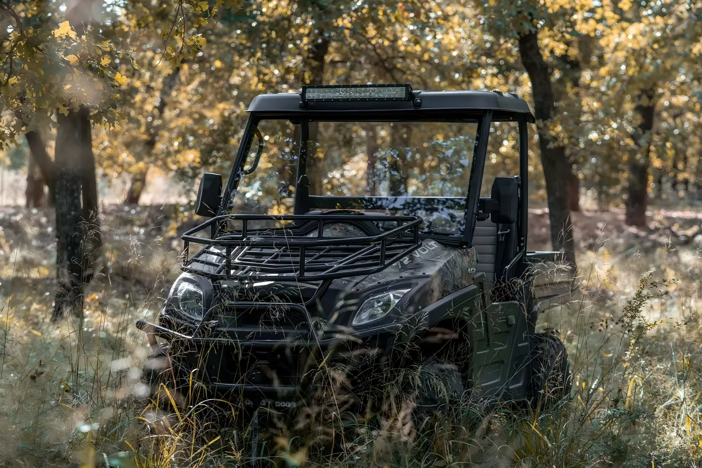Front view of a gasoline UTV parked in a woodland environment for farm work and trail exploration