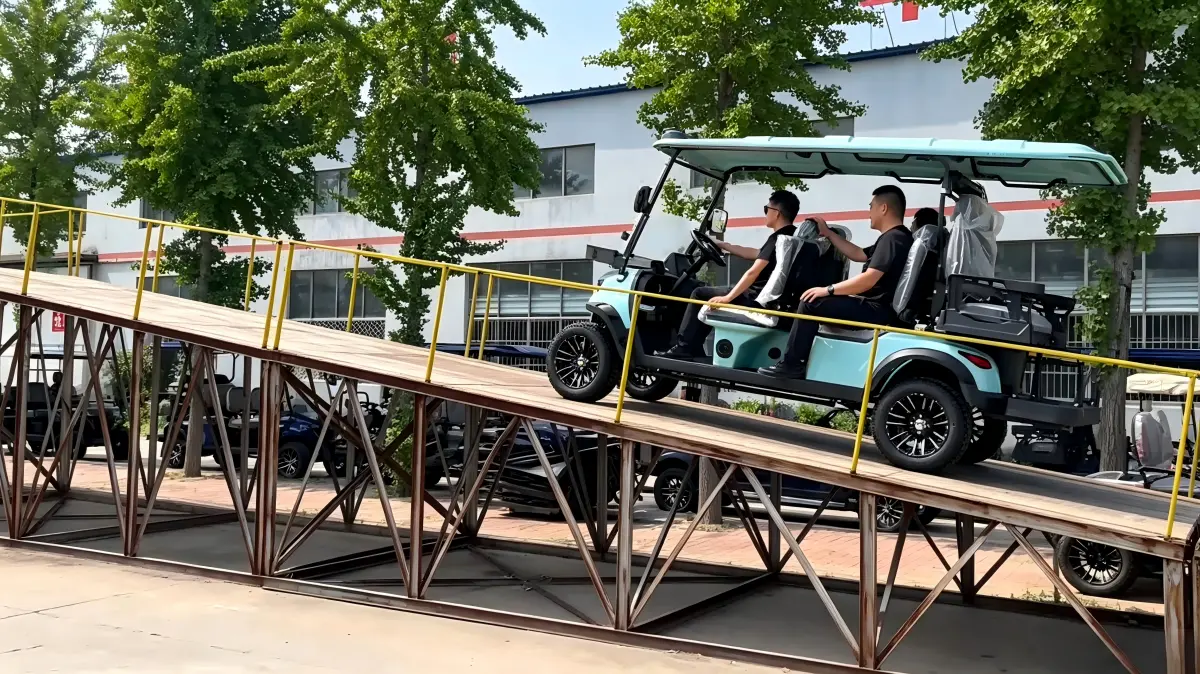 Electric golf cart tested for hill climbing performance and hill-hold control on a steep incline ramp under a full load.