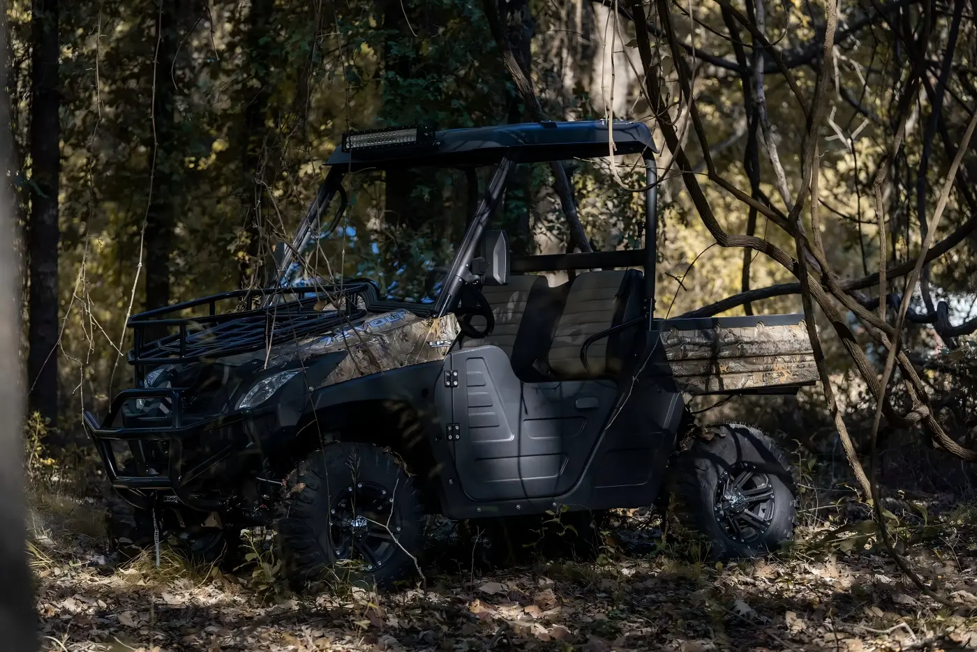 Custom fuel UTV parked in a rugged woodland environment for outdoor exploration