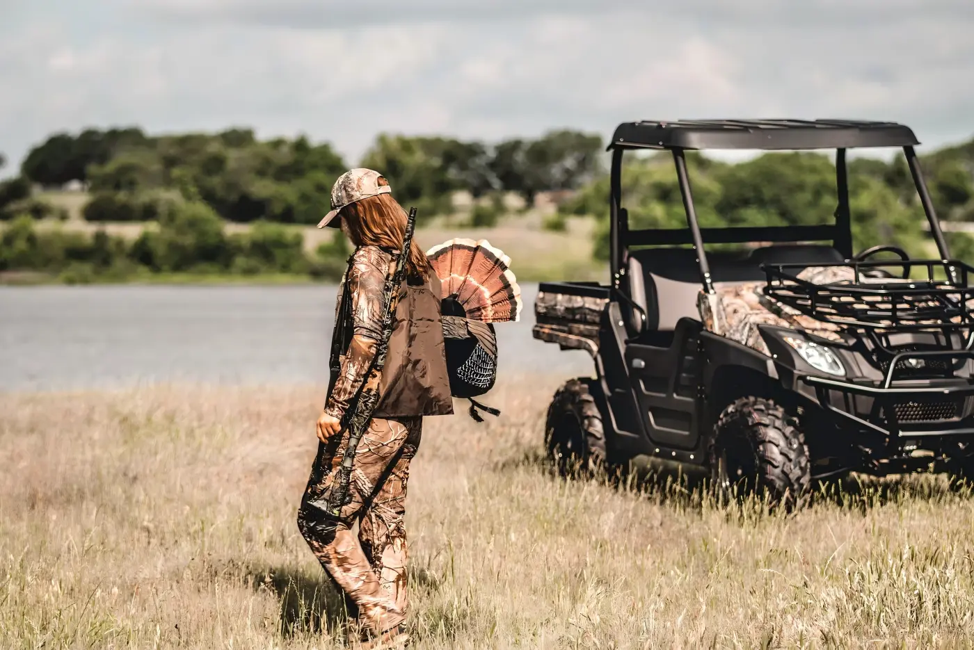 Field personnel near a commercial gasoline UTV during outdoor ranch and farm operations