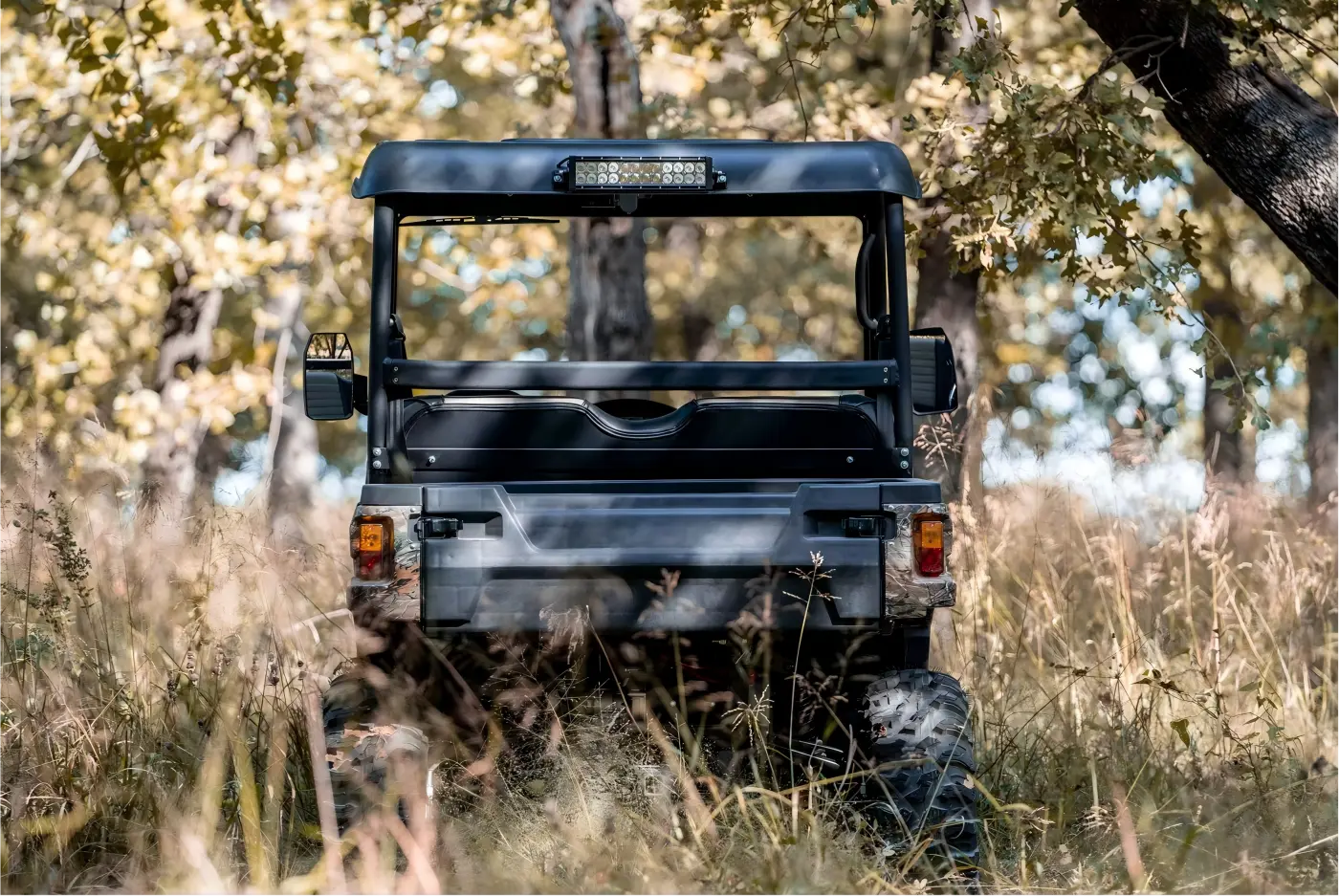 Gasoline UTV navigating through a rugged woodland environment for farm work and trail exploration