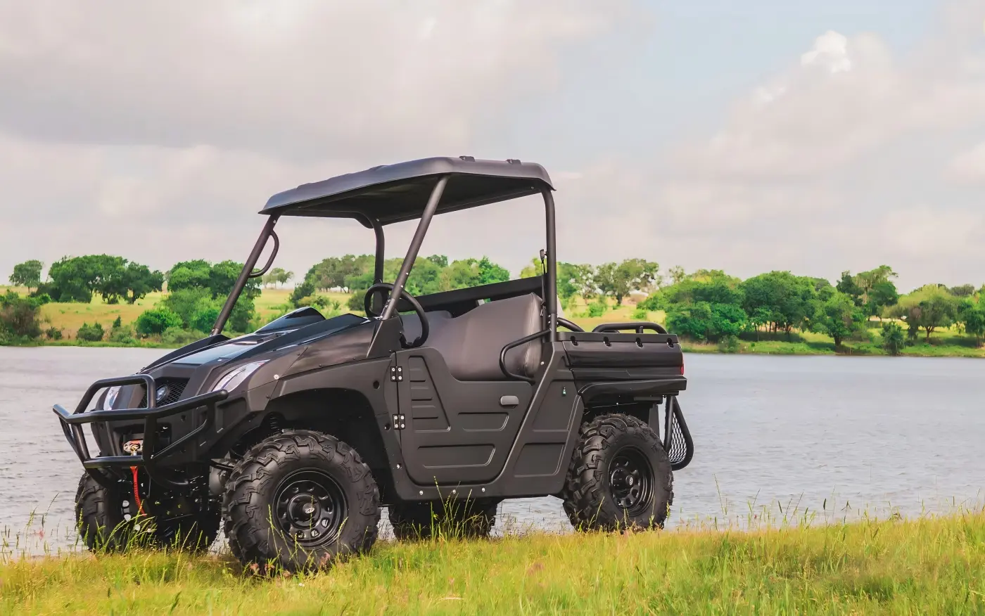 Commercial 4-seat gasoline UTV parked in an outdoor field for farm and utility operations