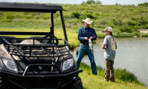 A high-performance 4WD electric UTV off-road vehicle navigating complex farmland terrain for efficient agricultural operations.
