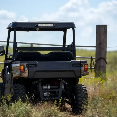A fuel-powered UTV performing farm duties and off-road tasks in an outdoor field, demonstrating high load capacity and all-terrain versatility.