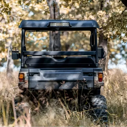 Gasoline UTV navigating through a rugged woodland environment for farm work and trail exploration