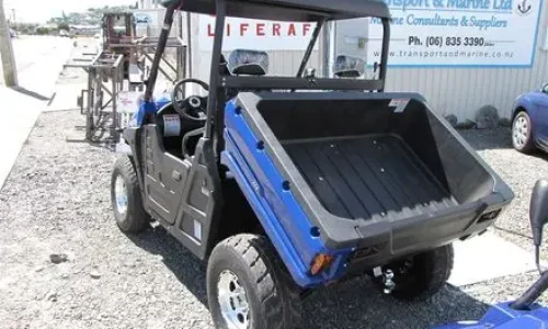 Electric utility vehicle with integrated heavy-duty cargo bed and dump box configuration