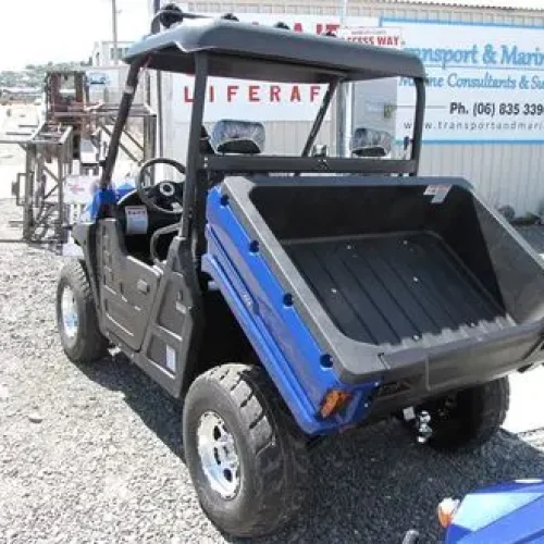 Electric utility vehicle with integrated heavy-duty cargo bed and dump box configuration
